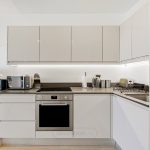 Modern kitchen with appliances and workspace area.