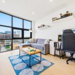 Modern living room with large windows and workspace