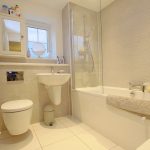 Modern bathroom with bathtub and sink.