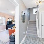 Modern hallway and living room with staircase.