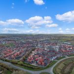 Aerial view of suburban housing estate and countryside.
