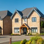 Brick house with modern design on sunny day.