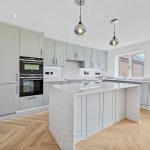 Modern kitchen with grey cabinets and island