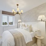 Modern bedroom with neutral decor and cosy lighting.