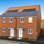 Modern semi-detached houses with solar panels.