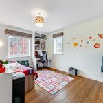 Children's room with superhero toys and planet decor.