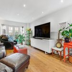 Spacious living room with modern decor and plants.