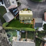 Aerial view of suburban houses and gardens.