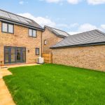 Modern house with solar panels and garden.