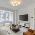Modern living room with large window and TV.