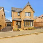 Modern detached brick house with garage and driveway.