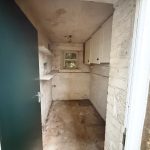 Empty storeroom with stone walls and wooden door