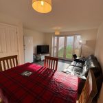 Living room with dining area and garden view.