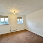 Empty room with carpet and windows