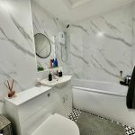 Modern bathroom with marble walls and shower
