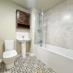Modern bathroom with patterned floor tiles.