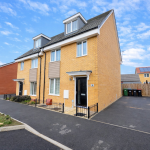 Modern brick semi-detached house on suburban street.