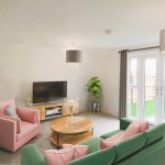 Modern living room with TV and sofas.