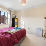 Cosy bedroom with natural light and simple decor.