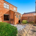 Brick house entrance with garden path.