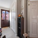 Home entrance with shoes and storage unit.