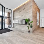 Modern office lobby with mailboxes and large windows.