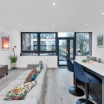 Modern open-plan living room with large windows.