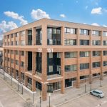 Modern brick office building under blue sky.