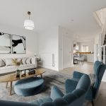 Modern living room with blue chairs and staircase