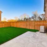 Modern garden with fenced lawn and patio