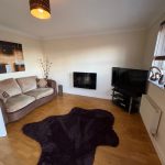 Cosy living room with sofa and TV