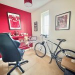 Home office with bike and football decor.