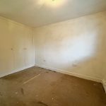 Empty room with built-in wardrobe and window