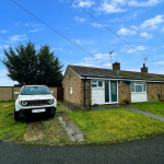UK suburban bungalow with parked SUV