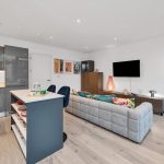 Modern open-plan living room and kitchen.