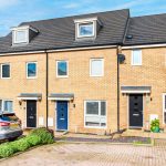 Modern terraced houses with parked car nearby.