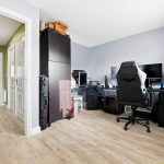 Home office with dual monitors and gaming chair.