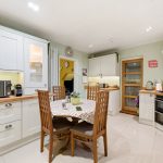 Modern kitchen with wooden dining table.