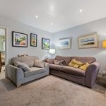 Cosy living room with sofas and wall art.