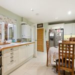 Cosy kitchen with table and modern appliances.