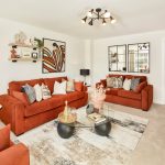 Modern living room with orange sofas and decor.