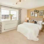 Modern bedroom with double bed and wall art.