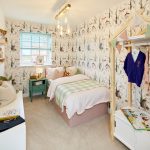 Child's bedroom with animal-themed wallpaper and toys.