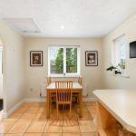 Bright kitchen dining area with wooden furniture.