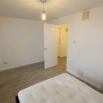 Minimalist bedroom with bed and open door