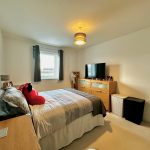 Cosy bedroom with double bed and TV.
