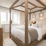 Elegant bedroom with wooden canopy bed and neutral decor.