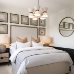 Modern bedroom with stylish decor and wall art.