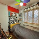 Colourful music-themed bedroom with guitars and posters.