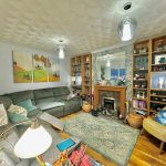 Cosy living room with a fireplace and decorations.